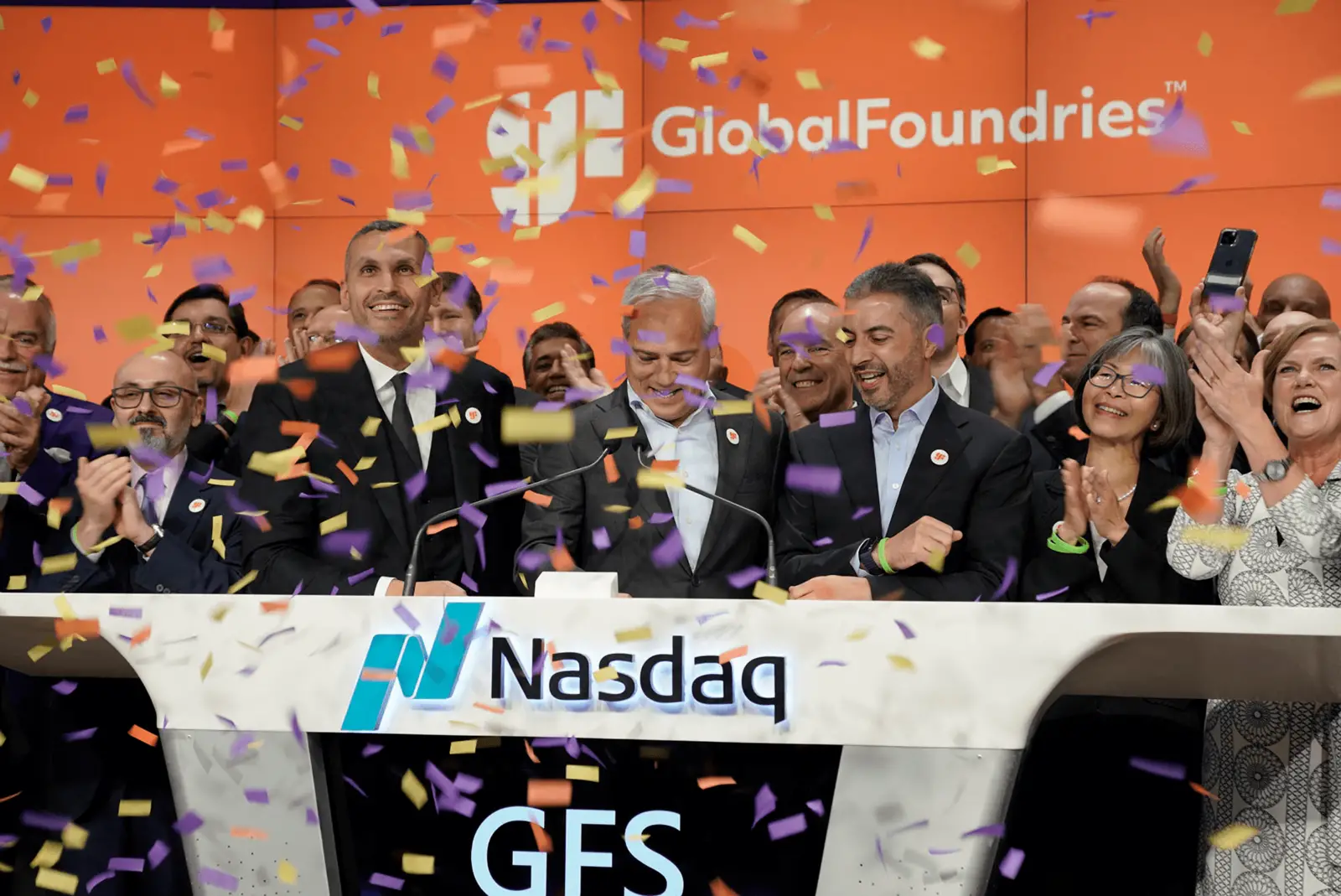 Co-workers celebrating on stage with confetti
