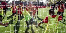 Soccer team in play in front of net