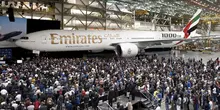 Crowd of people around Emirate plane