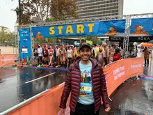 Smiling man standing in front of start line at the race